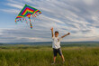© Tina kids photo - little boy launches a kite in the summer