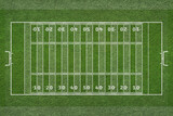 Empty striped american football field texture. Green grass texture - well-groomed turf and tactics lines.