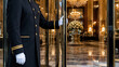© Rifqi Zakiri - Hotel doorman opening glass door to a luxury marble lobby