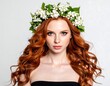 © Tukul - A beautiful young woman with long, flowing red hair and a floral crown