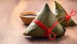 © Erik - zongzi sticky rice dumpling wrapped in bamboo leaves with red string