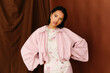 © Tania Cervian/Stocksy - Woman in pink jacket and floral bodysuit
