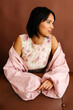 © Tania Cervian/Stocksy - Woman posing wearing floral dress a