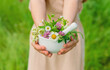 © yanadjan - A woman collects medicinal herbs. Selective focus.