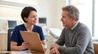 © Sterillens - Friendly nurse discussing health results with a mature male patient