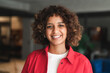 © Stock 4 You - Beautiful latin or muslim arabian young woman businesswoman with curly hair looking at camera indoors in office, lifestyle portrait. Indian girl teenager student smiling standing in university campus