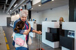 © Marko - Two travelers share a moment at the airport check-in area before their journey begins