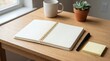 © Pris - Open Blank Notebook with Pen Mug and Potted Plant on Wooden Desk