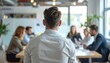 © Ahmad - Young Businessman Facing Team Discussion in Bright Modern Office Meeting Room