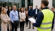 © Jafree - Fire marshal leading group of office workers during building evacuation drill. Security officer giving safety instructions to colleagues at workplace. Emergency preparedness training concept