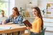 © Pixel-Shot - Female student studying at table in classroom