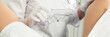 © Maria - Cropped panorama of gynecologist examining a patient who is sitting in a gynecological chair. Female health concept.