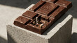 © RISHAD - Chocolate bar with broken square revealing miniature archaeological excavation site stone statues