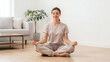 © Boontharika - Hormone Balance Concept Serene Woman Practicing Yoga on Floor for Endocrine Balance