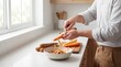 © Khampasert - Man Peeling Fresh Carrot over Ceramic Bowl on Kitchen Counter