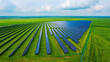 © Sabbir Media - Aerial view of large solar farm renewable energy power plant on green grass field with renewable