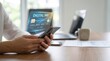 © arina - Person using smartphone for secure digital payment, with holographic credit card information projected from mobile phone, illustrating modern mobile banking and online transaction security.