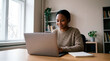 © Rendara Studio - Focused Black professional woman working attentively on laptop at home desk and study