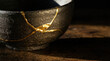 © jittam - Beautifully repaired ceramic bowl with gold accents, showcasing artistry and elegance