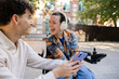© AresStudio Belen y Carlos/Stocksy - Young friends enjoying shared content on smartphone, laughing