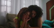 © Marco - Mother providing gentle support to teenage daughter sitting on couch, emotional connection and family care, women of African descent in thoughtful moment at home