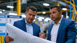 © Maksym Tereshchenko - Local elected official and factory manager review reshored electronics assembly line expansion blueprints at a newly opened domestic production facility, workforce hiring boards and American-made si