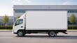 © Рудой Максим - White delivery truck parked on a street next to a large building during daytime