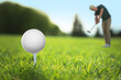 © New Africa - Golfer with club and ball on green course, selective focus