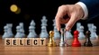 © resky - Strategic choice concept with businessman hand selecting silver rook chess piece among pawns near select blocks