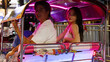 © blueringmedia - Smiling Young Couple Riding an Illuminated Tuk Tuk at Night