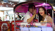 © blueringmedia - Young Asian Couple Enjoying a Tuk Tuk Ride Through Bangkok Night Market