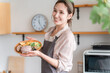 © buritora - A housewife preparing a one-plate lunch in the kitchen (cooking class, cooking school)