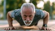 © kanesuan - Elderly Man Performing Push-Up Outdoor Regular Exercise and Fitness Routine