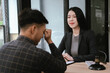 © Worawi - Female legal advisor reviewing and signing documents during a client consultation in a modern office, representing legal services, contracts, financial advice, compliance, and professionalism.