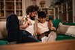 © Zoran Jesic - Father and son enjoying online shopping with tablet