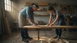 © Marc - A craftsman and an apprentice working together in a rustic workshop, illuminated by soft natural light.