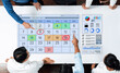 © InfiniteFlow - Business professionals collaborating on a digital calendar interface with data charts and visualizations for effective planning and decision-making. Bitwise.