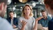 © Sunijsa - Woman speaks passionately during a business meeting