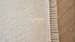 © Karim - Natural textured rug close-up showcasing gentle fibers and soft tones on hardwood floor, perfect for cozy interior design inspiration