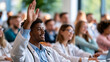 © Kateryna - Faceless smiling student in a white coat raising a hand in a bright sunlit lecture hall full of classmates soft daylight and greenery softly blurred medical education