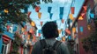 © Ryoichi - Person with backpack walks down colorful street with flags overhead