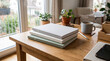 © kinkin - Stack of Minimalist Blank Hardcover Notebooks Resting on a Wooden Living Room Table
