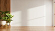 © Vanitjan - Minimalist empty room interior background with blank white wall for mockup, wooden floor, wood paneling, and tropical indoor plants- 3D rendering