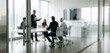 © Vhagar - A business meeting takes place behind a glass door, showcasing professionals discussing strategies in a modern office setting with a focus on teamwork.