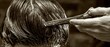 © COK House - A close-up view captures a stylist using scissors to trim wet hair against a blurred background, highlighting precision grooming.