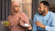 © Prostock-studio - Worried Black Woman Refusing Cake Offer From Smiling Male, Sitting In Living Room At Home With Healthy Salad Bowl. Scene Depicts Weight Loss And Healthy Eating Concept With Two Adults.