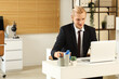© Pixel-Shot - Young businessman working with laptop and coffee at desk in office