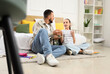 © Pixel-Shot - Teenage girl studying with tutor in bedroom