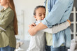 © Pixel-Shot - Little girl hugging her father after divorce at home