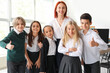 © Pixel-Shot - Little children with their teacher at school computer lab
